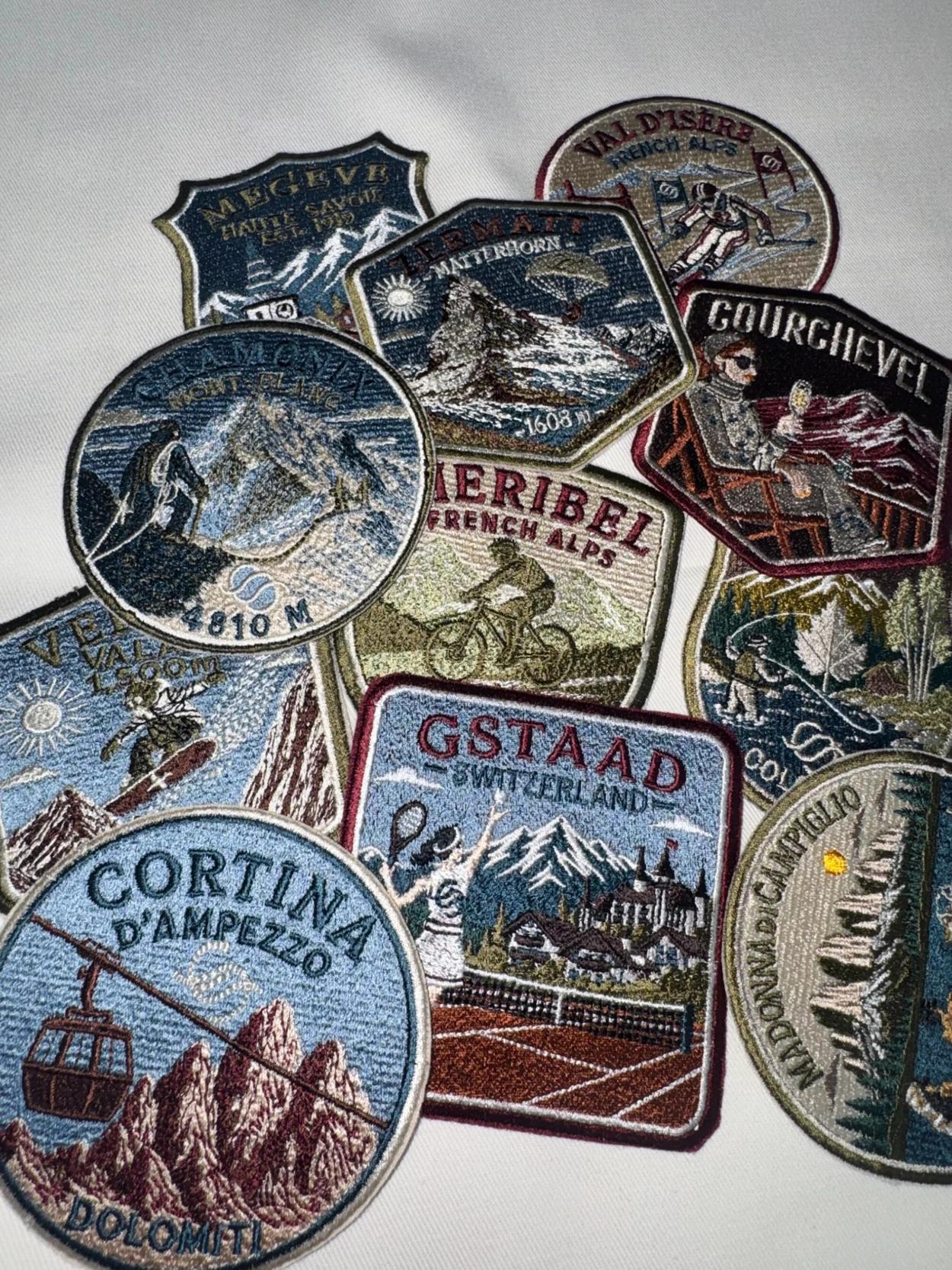 The completed collection of intricately embroidered alpine destination badges